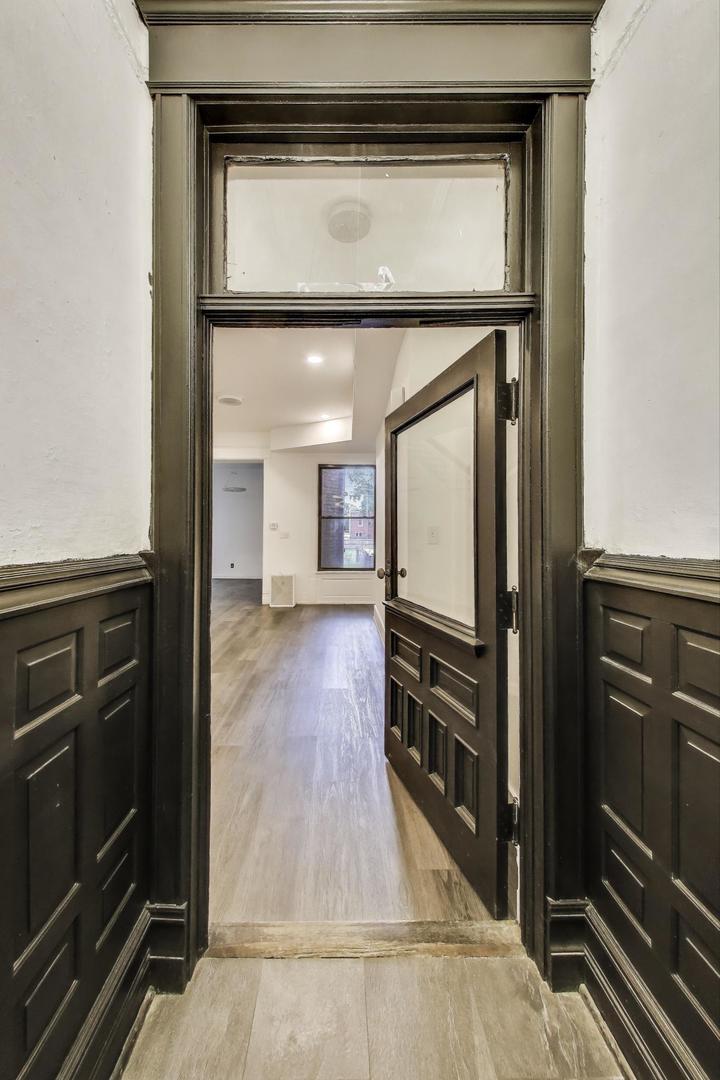 928 East 46th Street Chicago, IL 60653 - Photo 3 of 28 a view of a living room and a refrigerator
