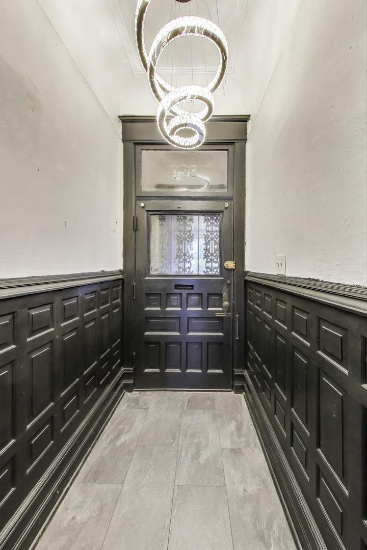 928 East 46th Street Chicago, IL 60653 - Photo 4 of 28 a kitchen with a stove and a wooden cabinets