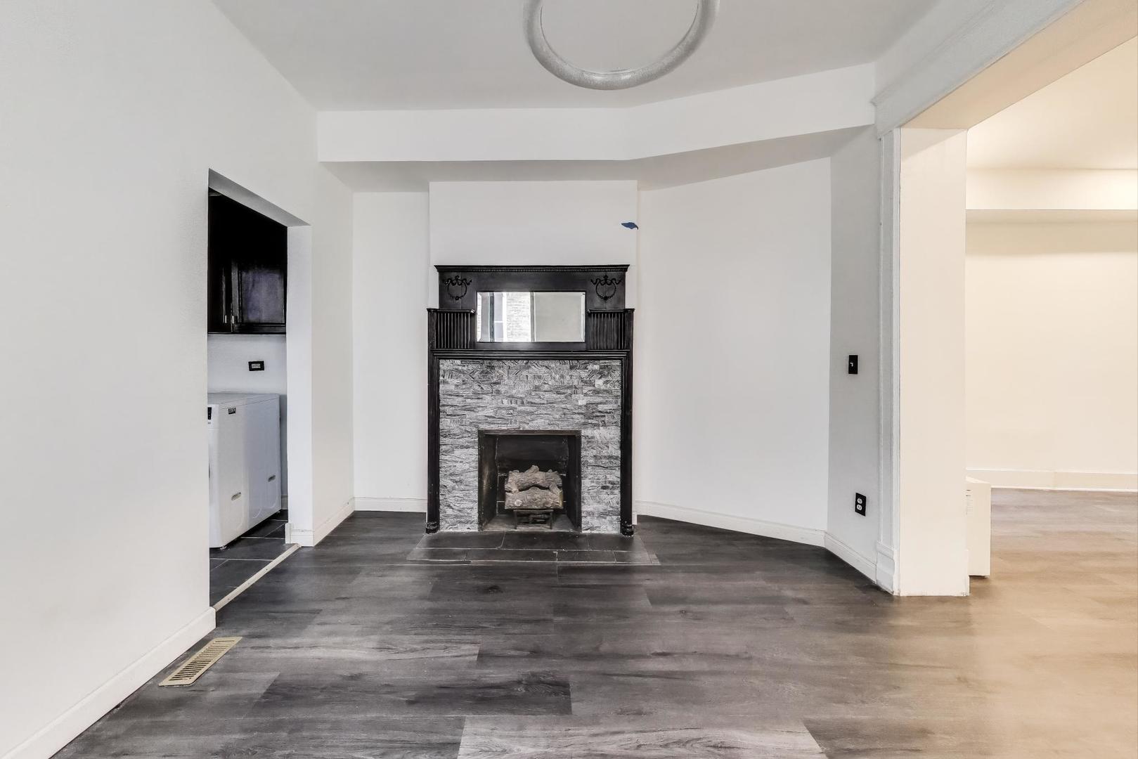 928 East 46th Street Chicago, IL 60653 - Photo 9 of 28 a living room with a fireplace and a flat screen tv