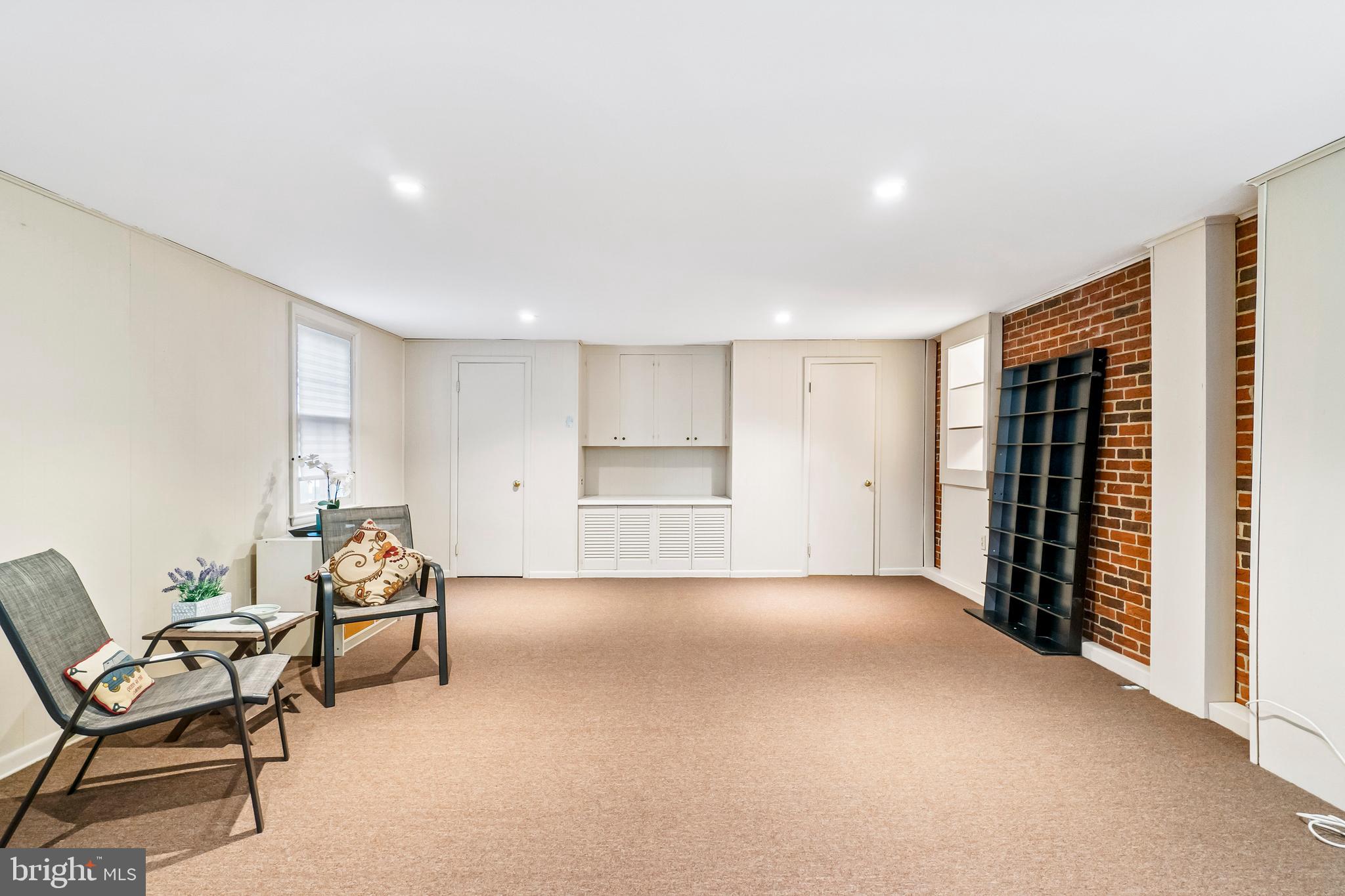 7021 Concord Road Baltimore, MD 21208 - Photo 14 of 39 Exposed brick wall and built ins in family room