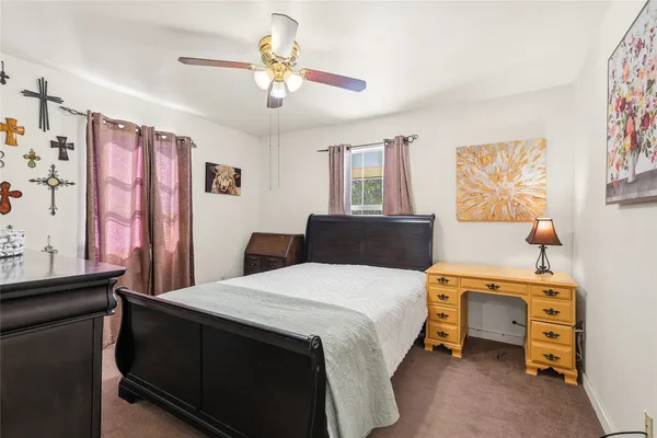 a bedroom with a bed and a dresser