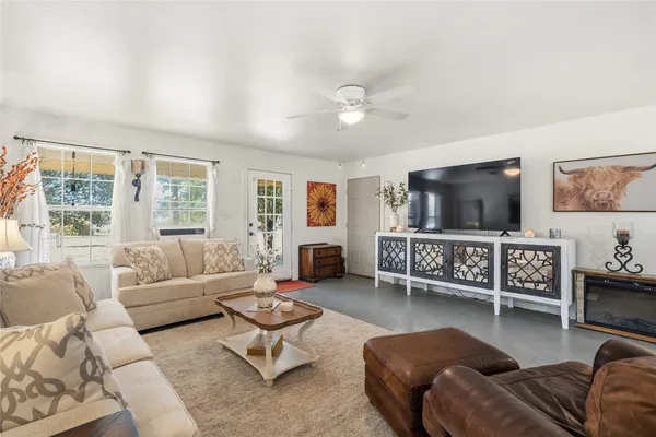 a living room with furniture and a flat screen tv