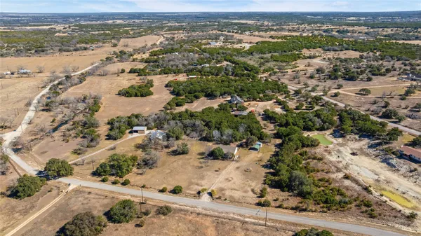 an aerial view of a house with a yard