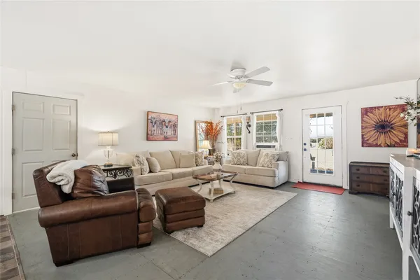 a living room with furniture or couch and a large window