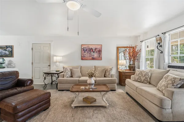 a kitchen with a refrigerator a stove a sink dishwasher a dining table and chairs with wooden floor