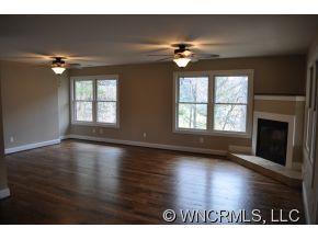 305 Nottingham Road Maggie Valley, NC 28751 - Photo 9 of 10 a view of an empty room with a window and wooden floor