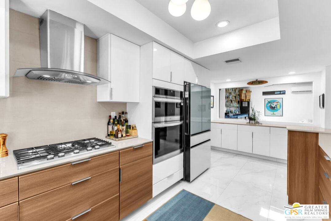 12 Santa Clara Drive Rancho Mirage, CA 92270 - Photo 11 of 34 a kitchen with stainless steel appliances granite countertop a stove and a refrigerator