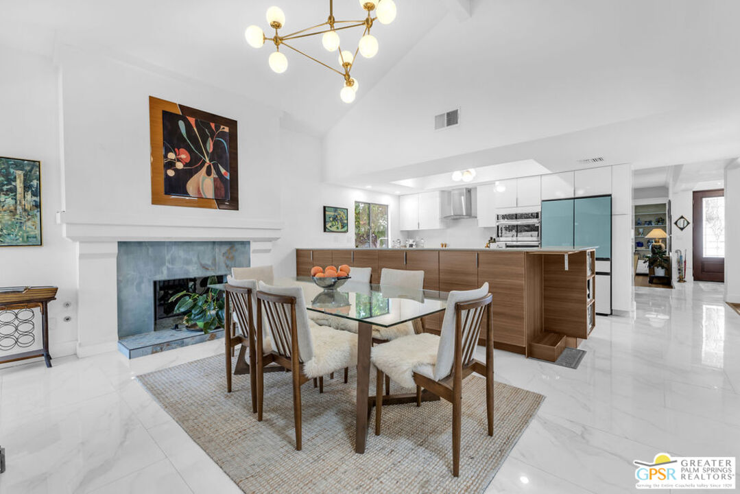 12 Santa Clara Drive Rancho Mirage, CA 92270 - Photo 2 of 34 a dining room with furniture and a fireplace