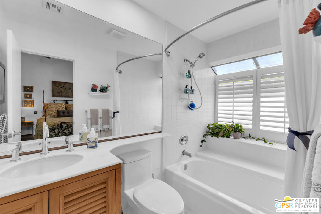 12 Santa Clara Drive Rancho Mirage, CA 92270 - Photo 24 of 34 a bathroom with a granite countertop sink toilet mirror and bathtub