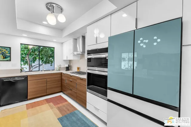 a large kitchen with a large window and stainless steel appliances