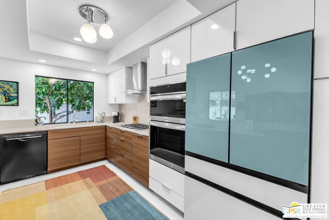 12 Santa Clara Drive Rancho Mirage, CA 92270 - Photo 10 of 34 a large kitchen with a large window and stainless steel appliances