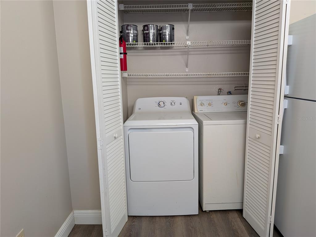 5613 Blue Shadows Court, Unit 2 Orlando, FL 32811 - Photo 11 of 26 a utility room with dryer and washer
