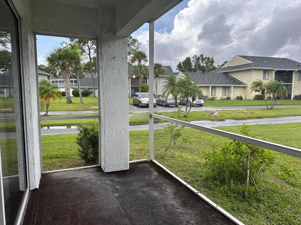 5613 Blue Shadows Court, Unit 2 Orlando, FL 32811 - Photo 21 of 26 a view of a house with a big yard and large tree