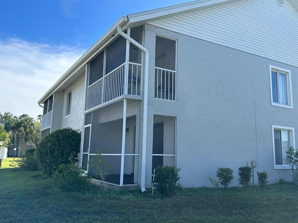 5613 Blue Shadows Court, Unit 2 Orlando, FL 32811 - Photo 22 of 26 a front view of a house with garden