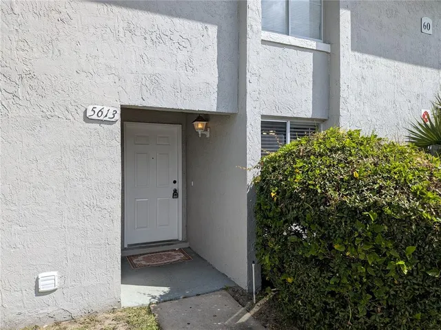a view of a room with wooden floor and a window