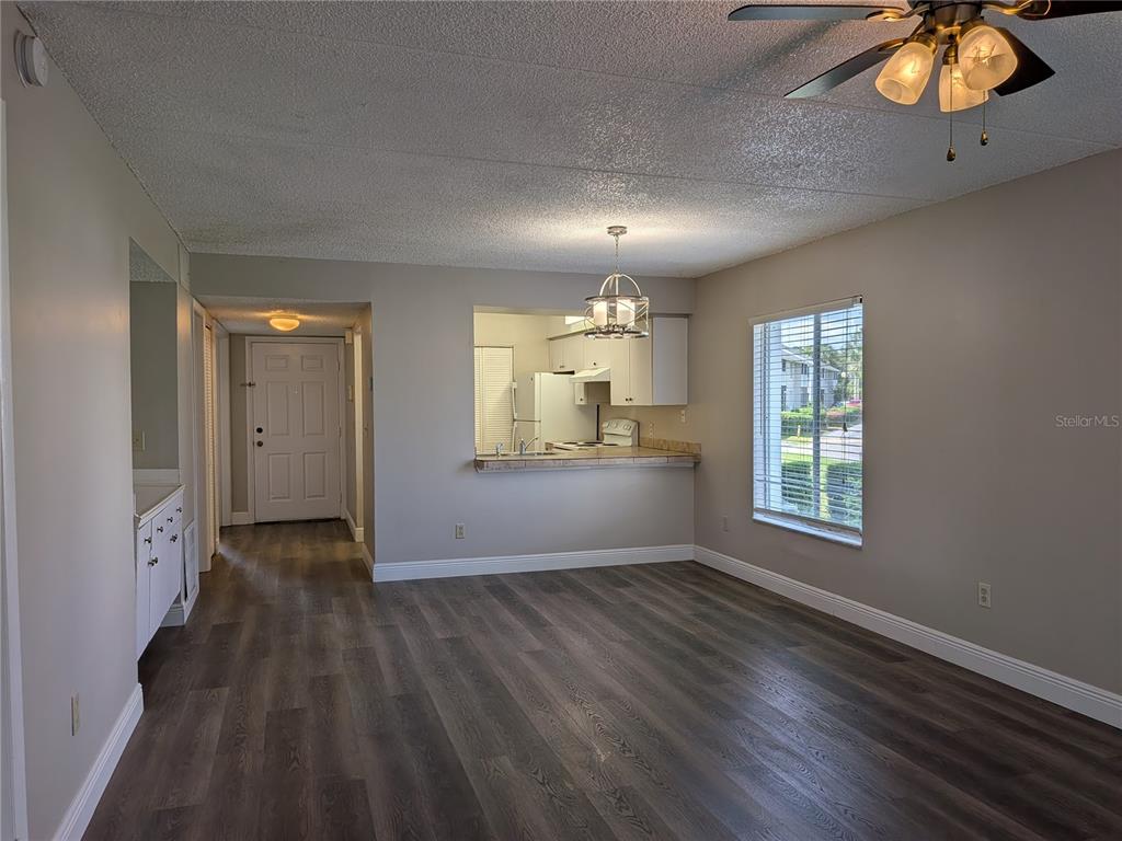 5613 Blue Shadows Court, Unit 2 Orlando, FL 32811 - Photo 5 of 26 wooden floor in an empty room with a window