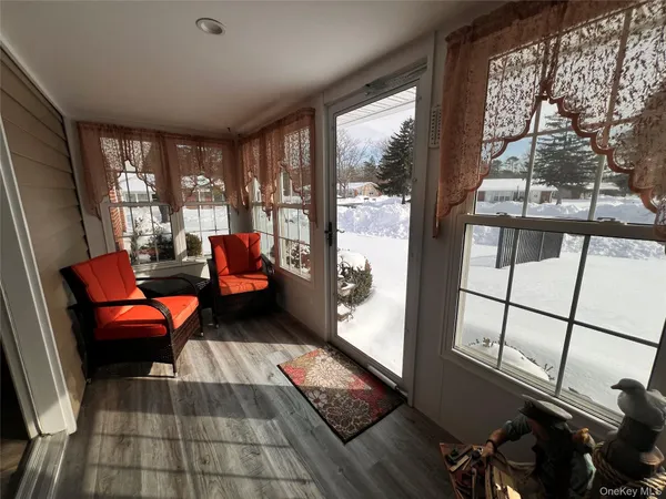 a living room with furniture and a floor to ceiling window