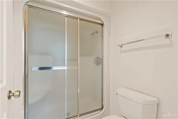a bathroom with a shower and toilet