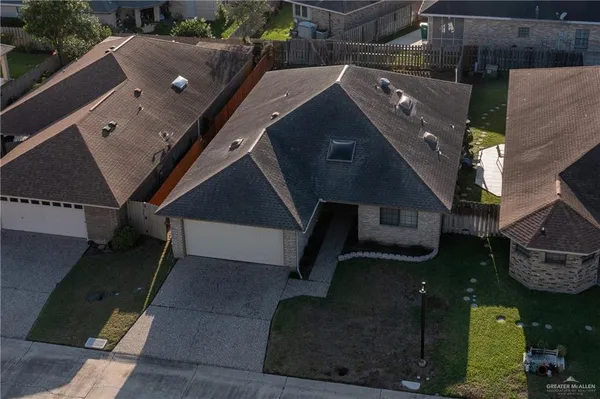 an aerial view of a house with a yard