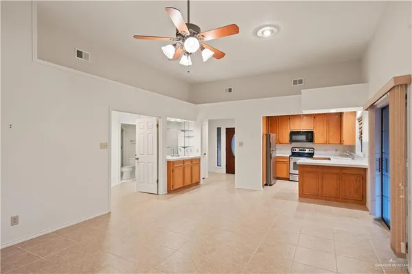 a view of kitchen with stainless steel appliances granite countertop a stove and a sink