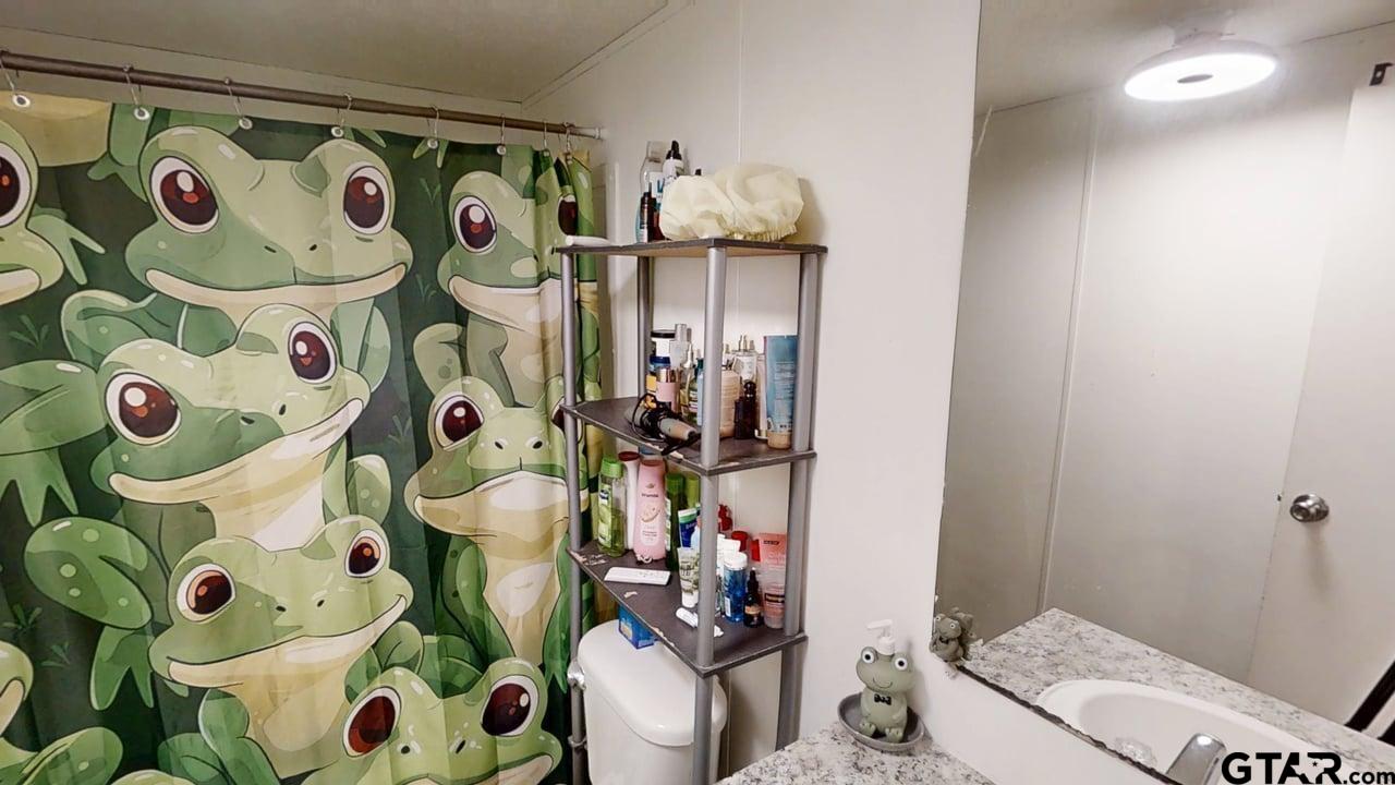 16910-c R 349 C R 349 Winona, TX 75792 - Photo 17 of 19 a bathroom with a toilet sink and mirror