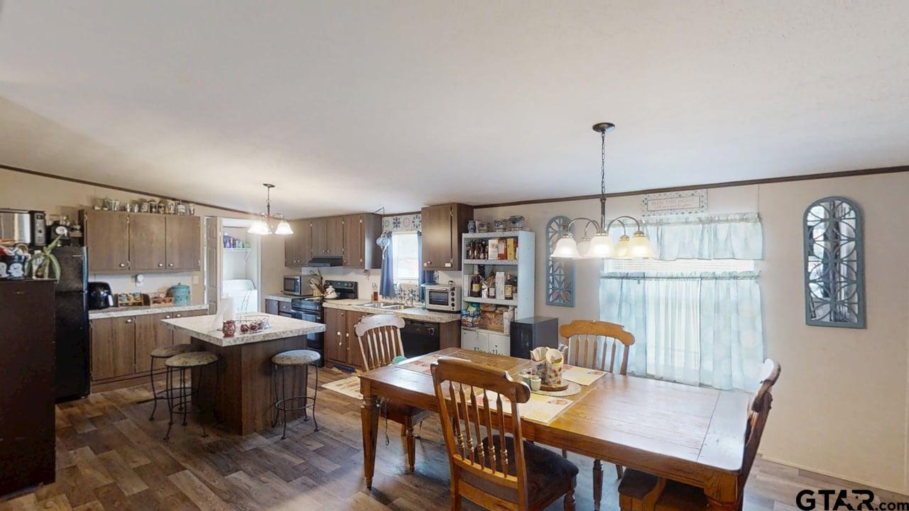16910-c R 349 C R 349 Winona, TX 75792 - Photo 5 of 19 a dining room with furniture a chandelier and wooden floor