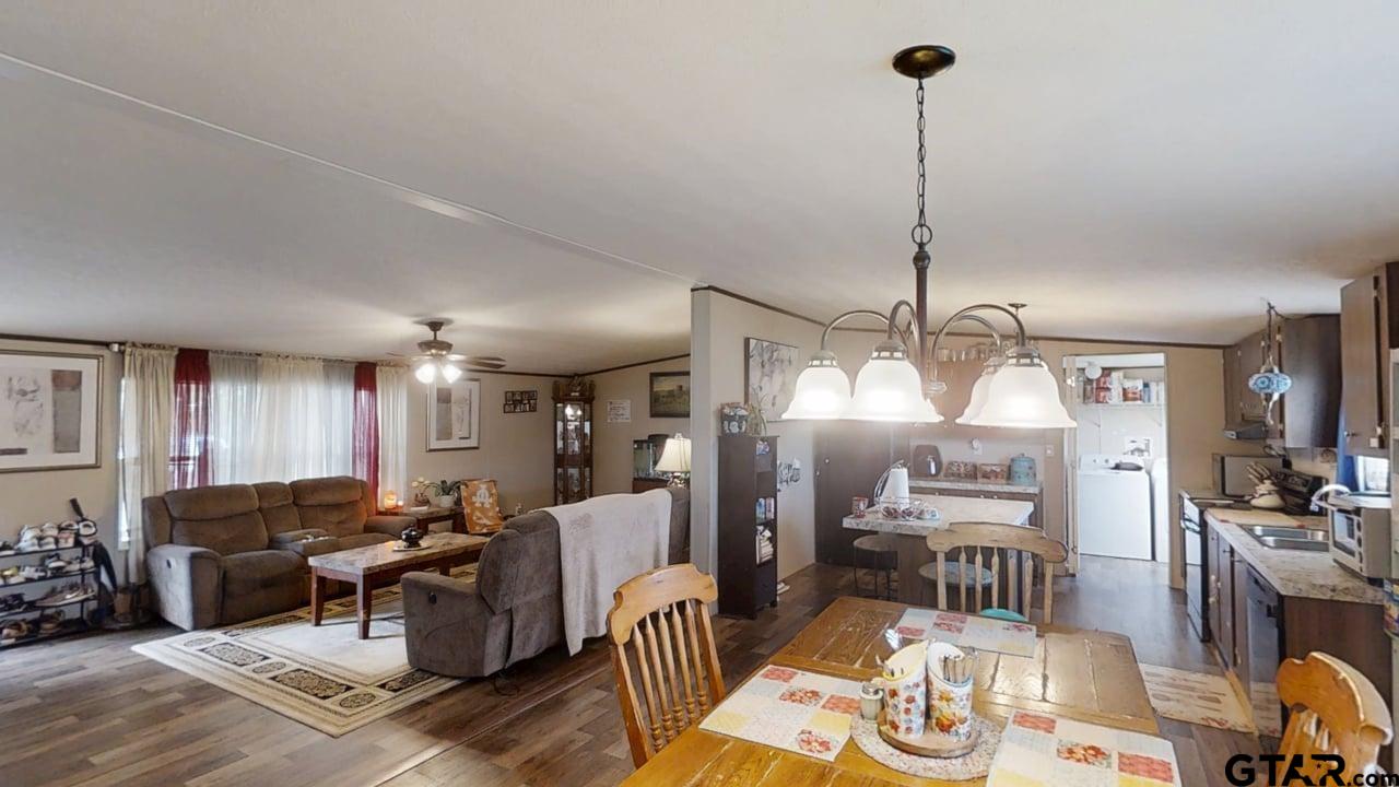 16910-c R 349 C R 349 Winona, TX 75792 - Photo 6 of 19 a living room with furniture a chandelier and a wooden floor