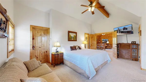 a bedroom with a bed and ceiling fan