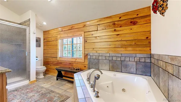 a bathroom with a bathtub and a shower