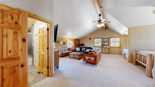 a view of a livingroom with furniture and a ceiling fan