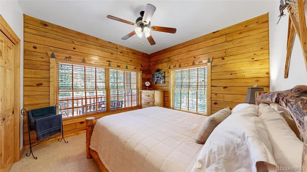 a bedroom with a bed next to a window