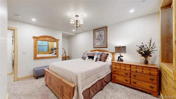 a bedroom with a bed and a dresser in it