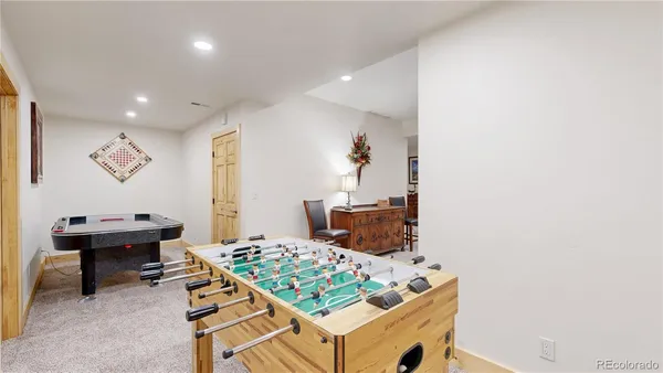 a living room with a piano and a table