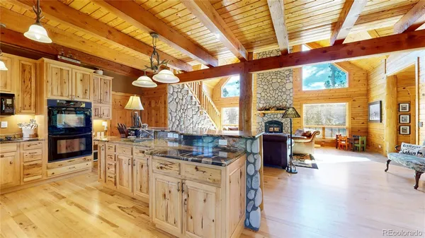 a kitchen with stainless steel appliances granite countertop a stove and cabinets