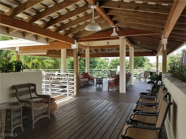 a patio with table and chairs and potted plants