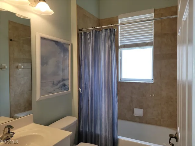 a bathroom with a shower and a sink