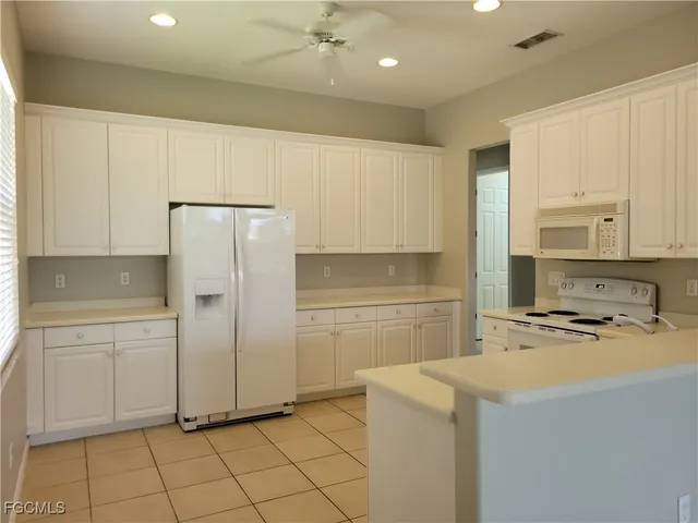 a kitchen with a refrigerator a stove a sink and a cabinets