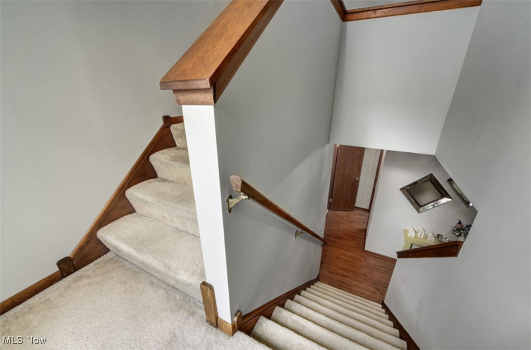 22536 Center Ridge Road, Unit A Rocky River, OH 44116 - Photo 19 of 32 Stairs with light carpet