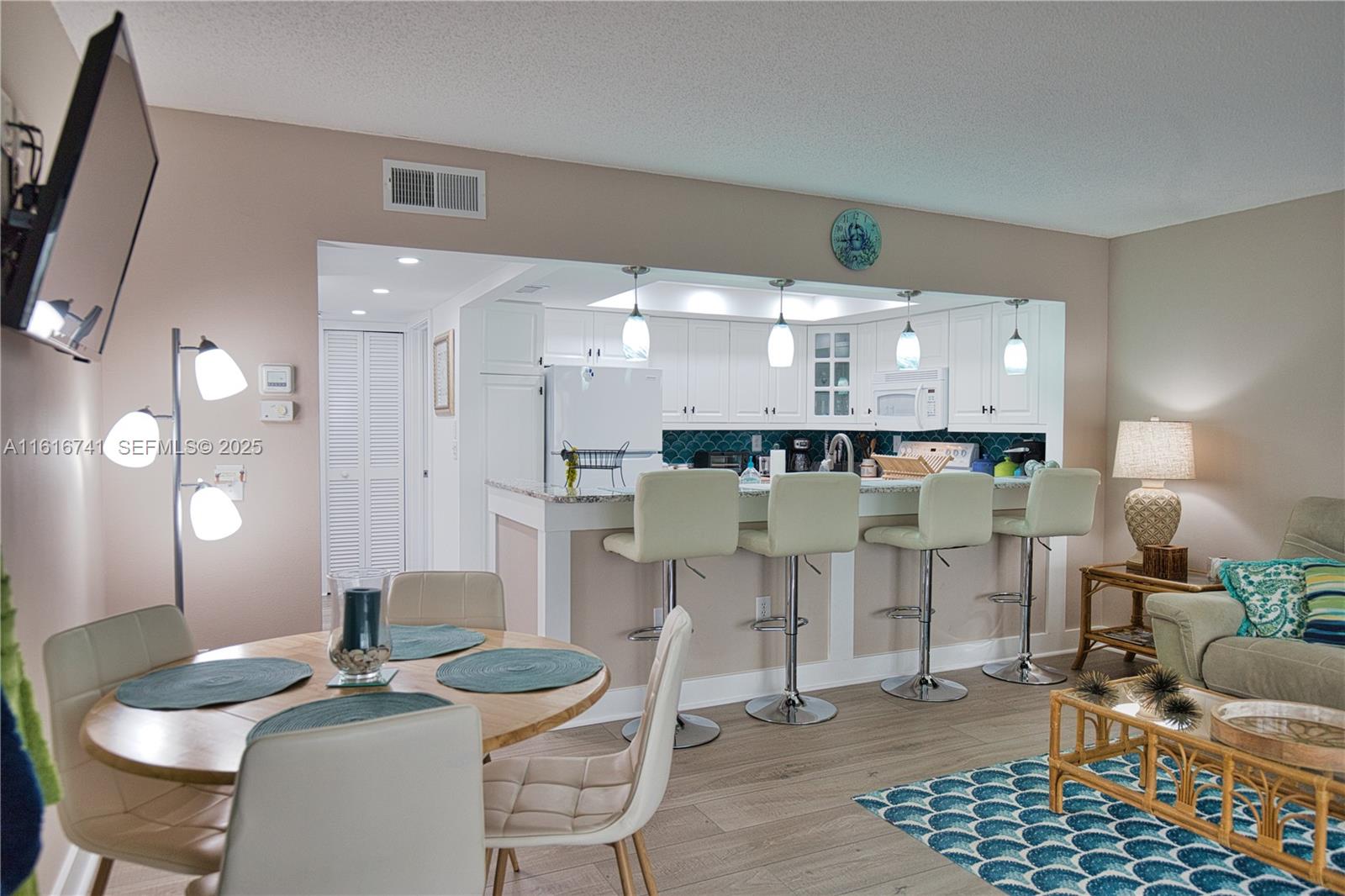 2810 North Beach Road, Unit D108 Englewood, FL 34223 - Photo 11 of 44 a view of a dining room with furniture