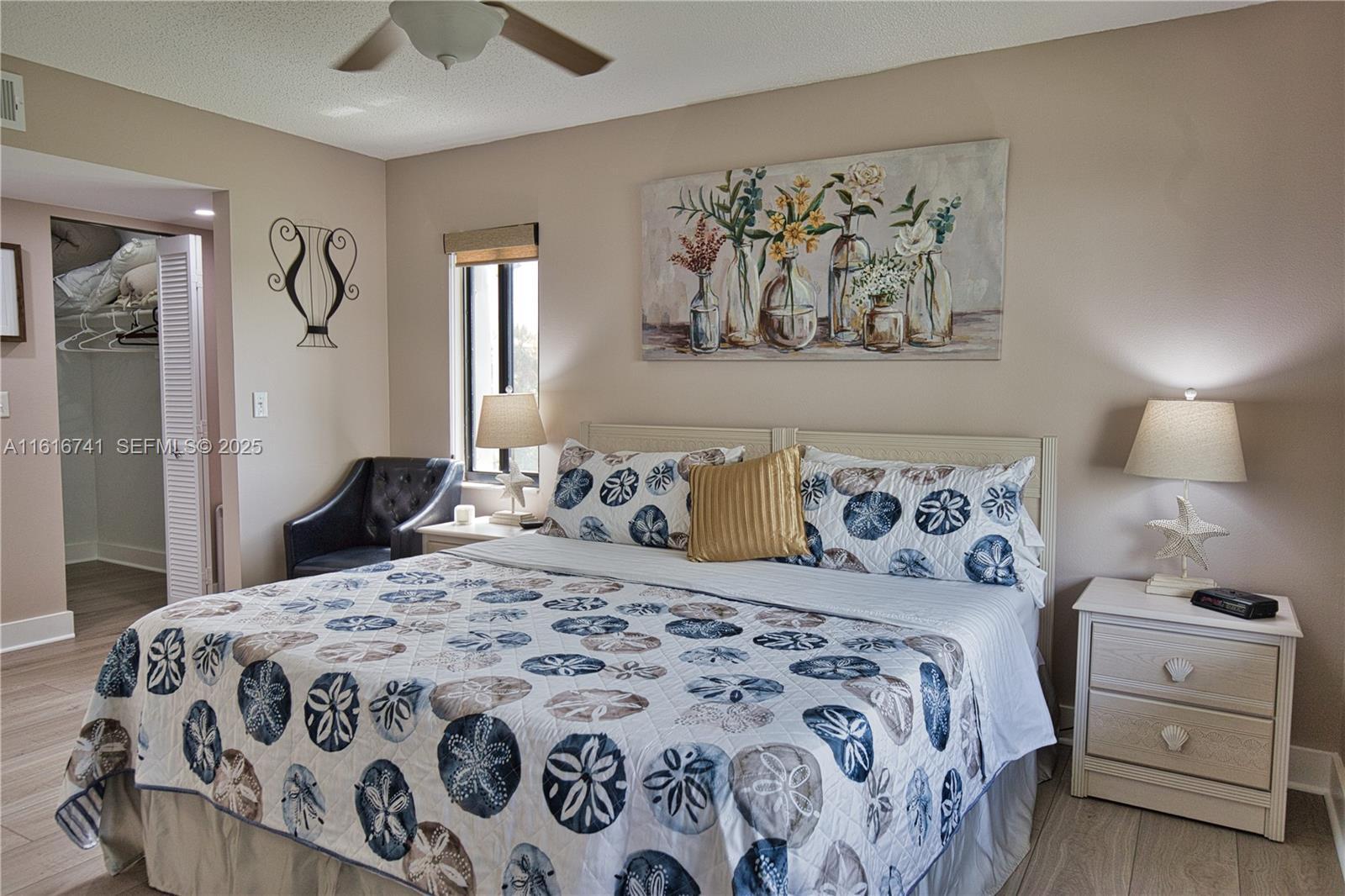 2810 North Beach Road, Unit D108 Englewood, FL 34223 - Photo 16 of 44 a bedroom with a bed and painting on the wall
