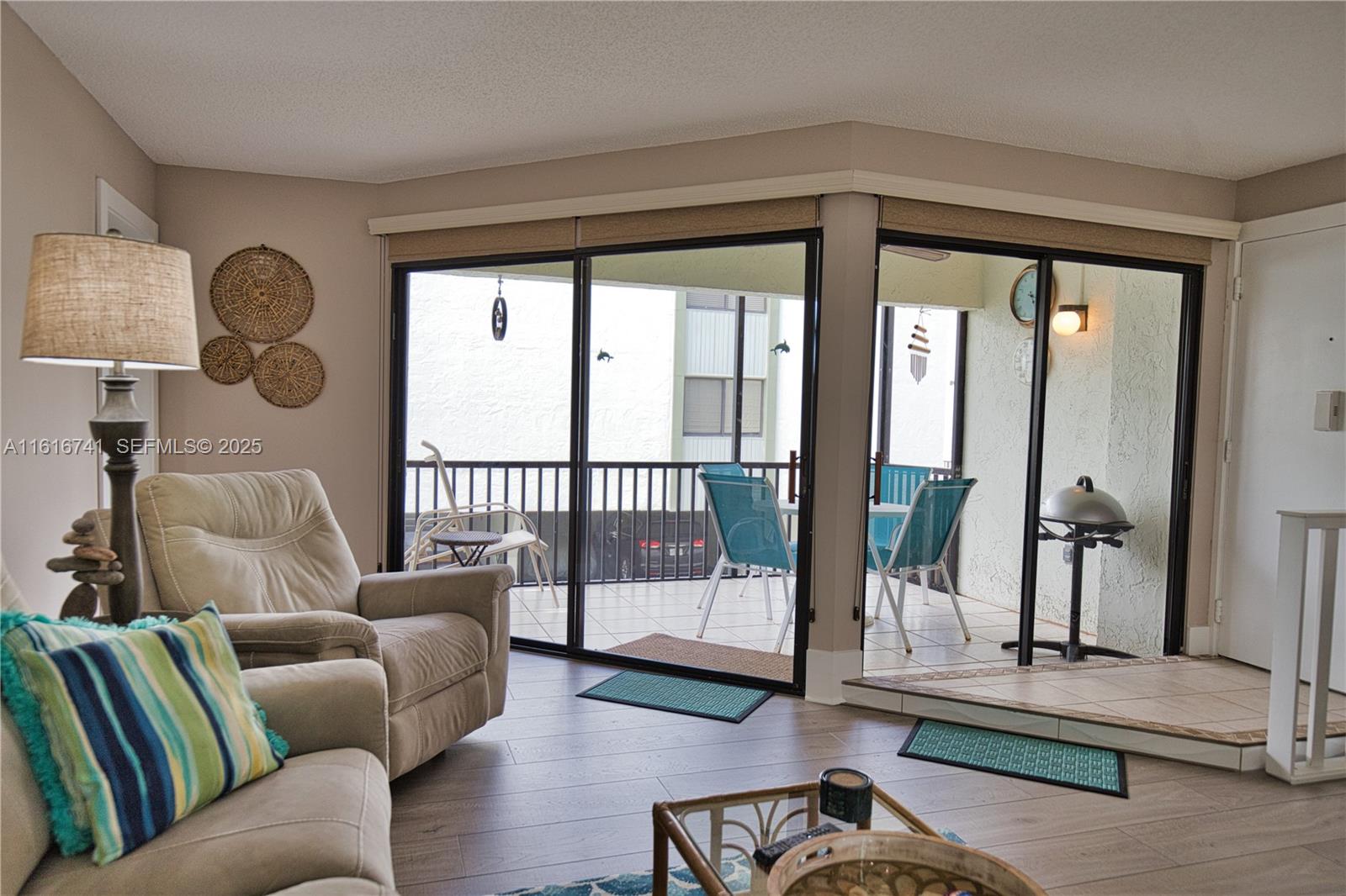 2810 North Beach Road, Unit D108 Englewood, FL 34223 - Photo 24 of 44 a living room with furniture and a large window