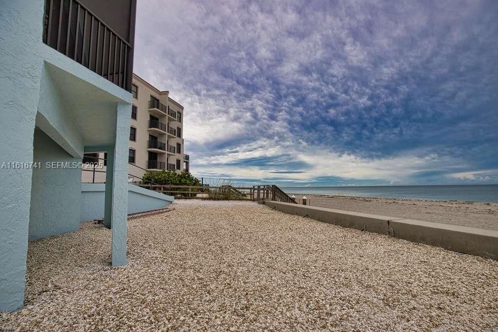 2810 North Beach Road, Unit D108 Englewood, FL 34223 - Photo 38 of 44 a view of a dry yard with wooden fence