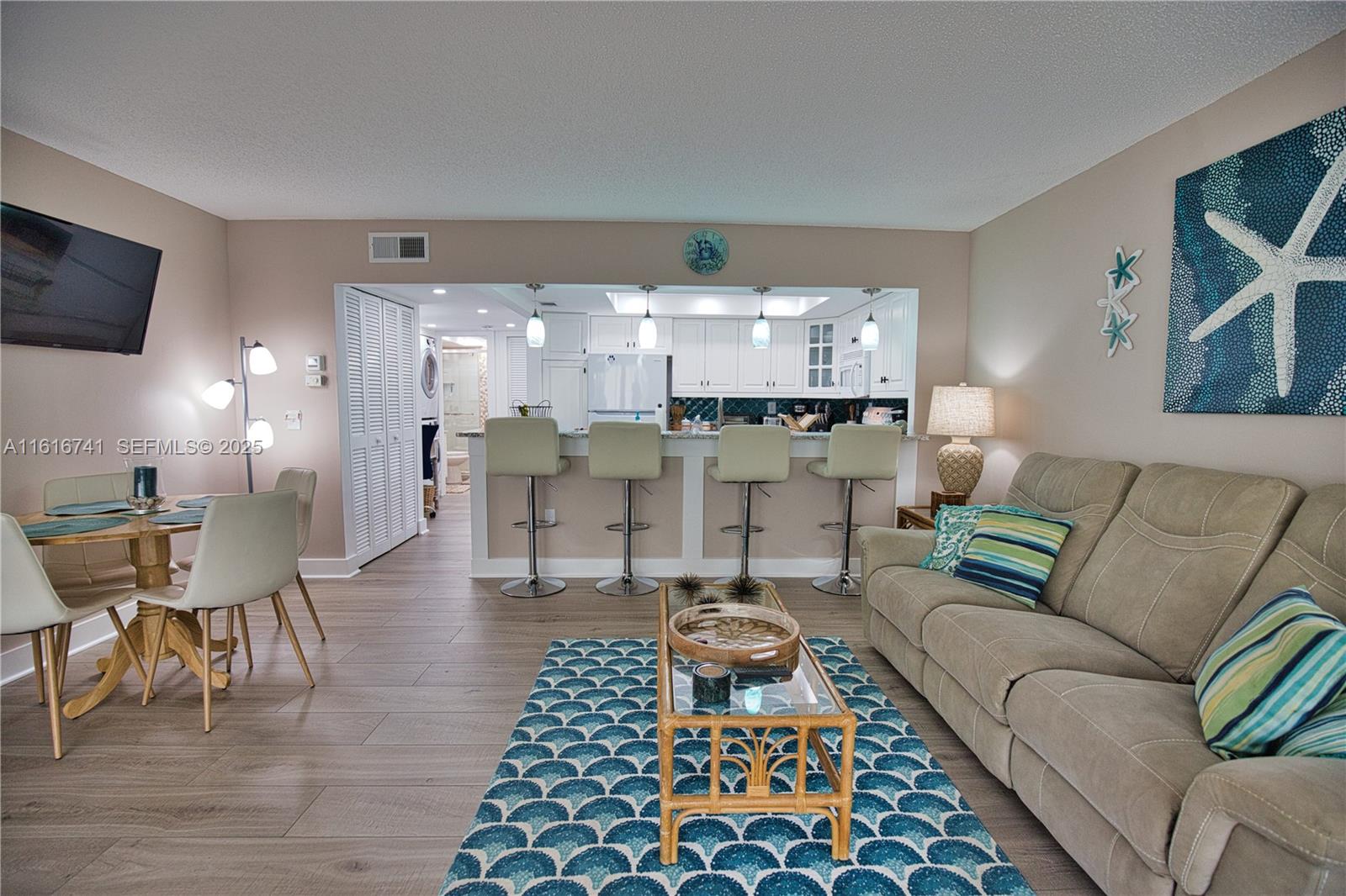 2810 North Beach Road, Unit D108 Englewood, FL 34223 - Photo 9 of 44 a living room with furniture and a rug