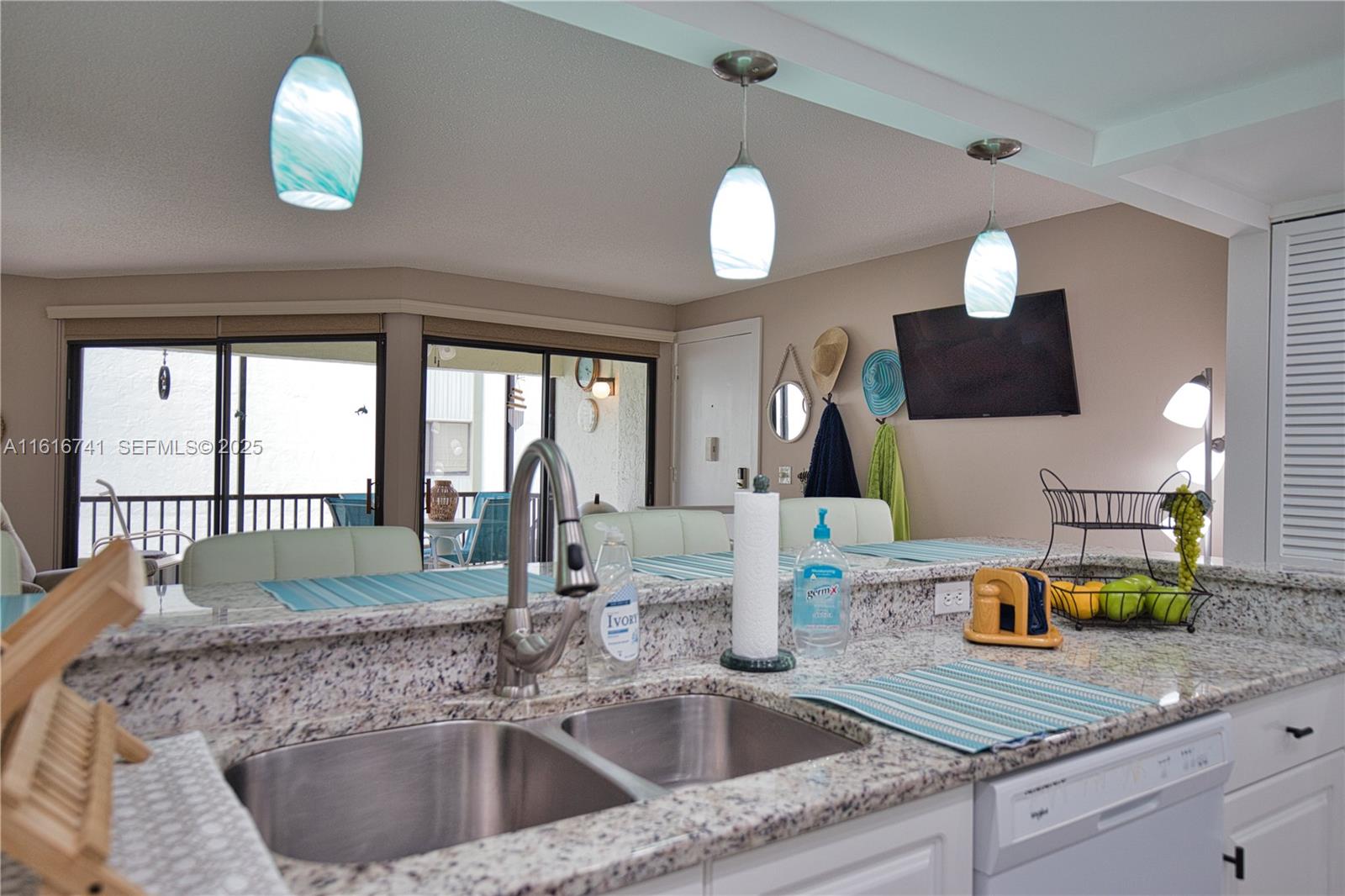 2810 North Beach Road, Unit D108 Englewood, FL 34223 - Photo 10 of 44 a kitchen with a sink and a window