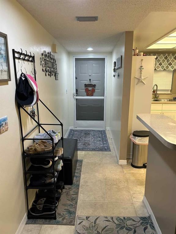 12900 Vonn Road, Unit B202 Largo, FL 33774 - Photo 2 of 23 a living room with a couch and a potted plant