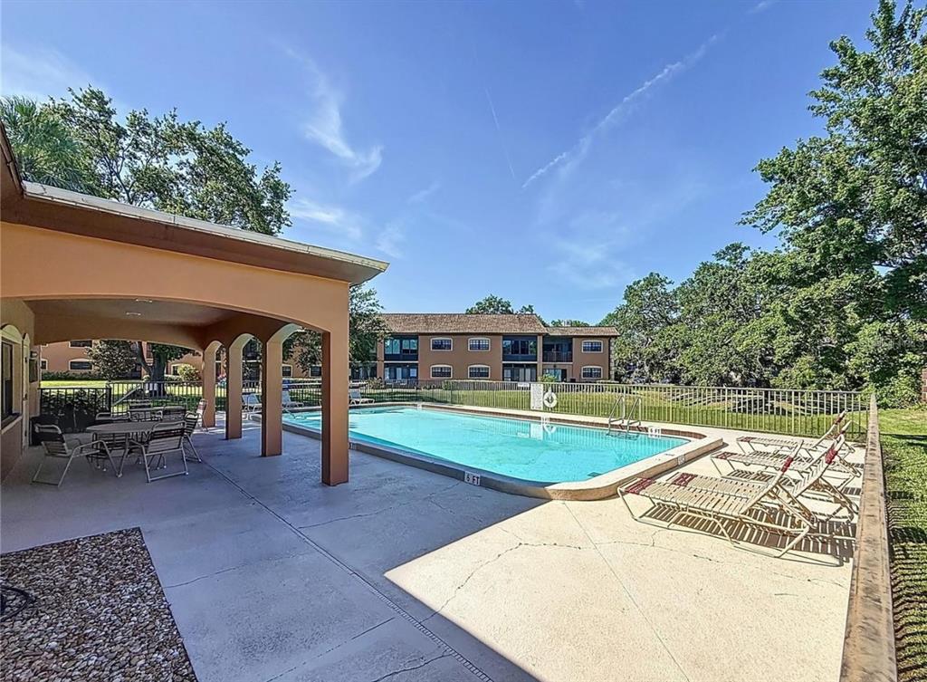 12900 Vonn Road, Unit B202 Largo, FL 33774 - Photo 22 of 23 a view of a swimming pool with a patio