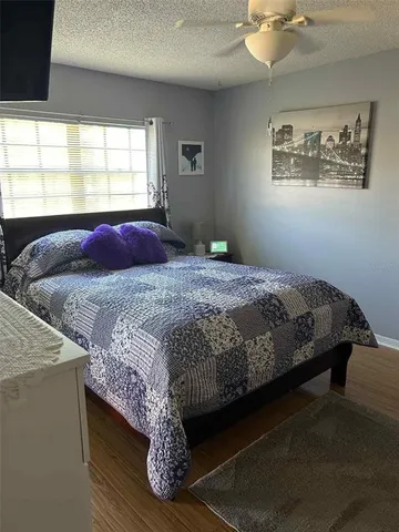 a bedroom with a bed and large windows