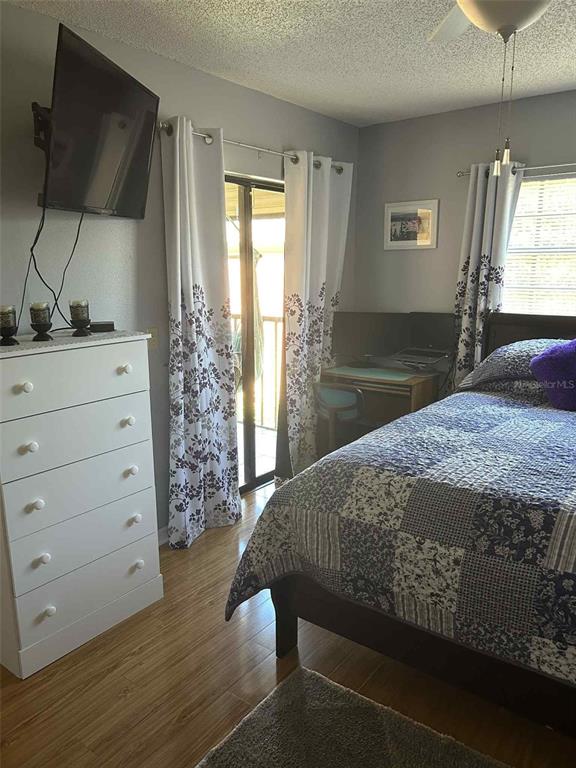 12900 Vonn Road, Unit B202 Largo, FL 33774 - Photo 9 of 23 a bedroom with a bed and large windows