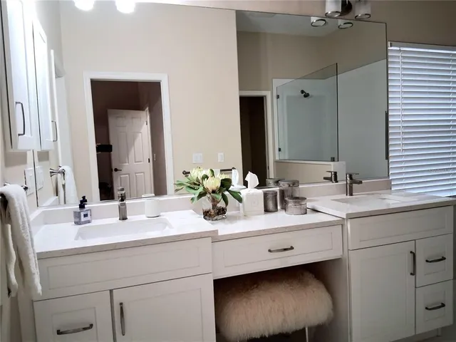 a bathroom with a double vanity sink mirror and