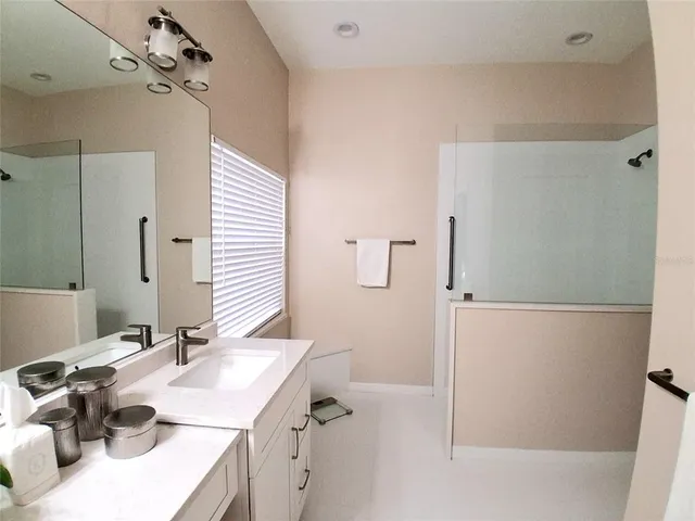 a bathroom with a sink vanity tub and shower